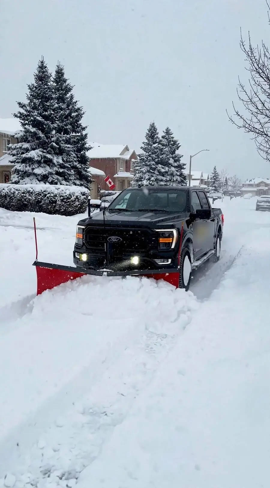 Plow truck clearing a snow-covered street