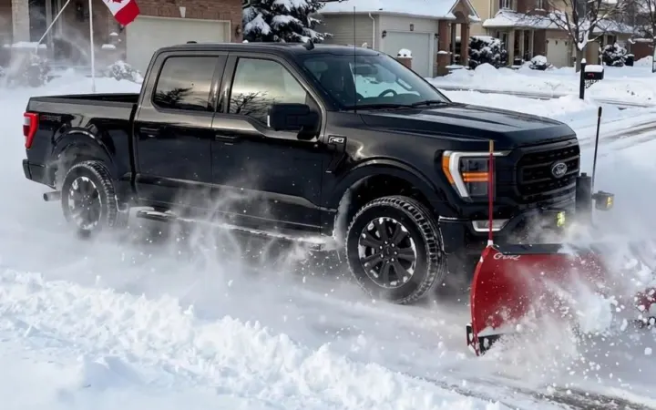 Plow truck pushing snow off the road