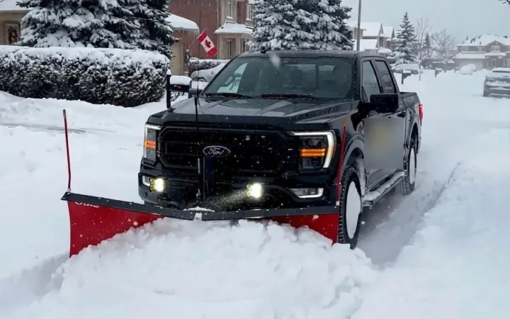 Plow truck clearing a snow-covered street