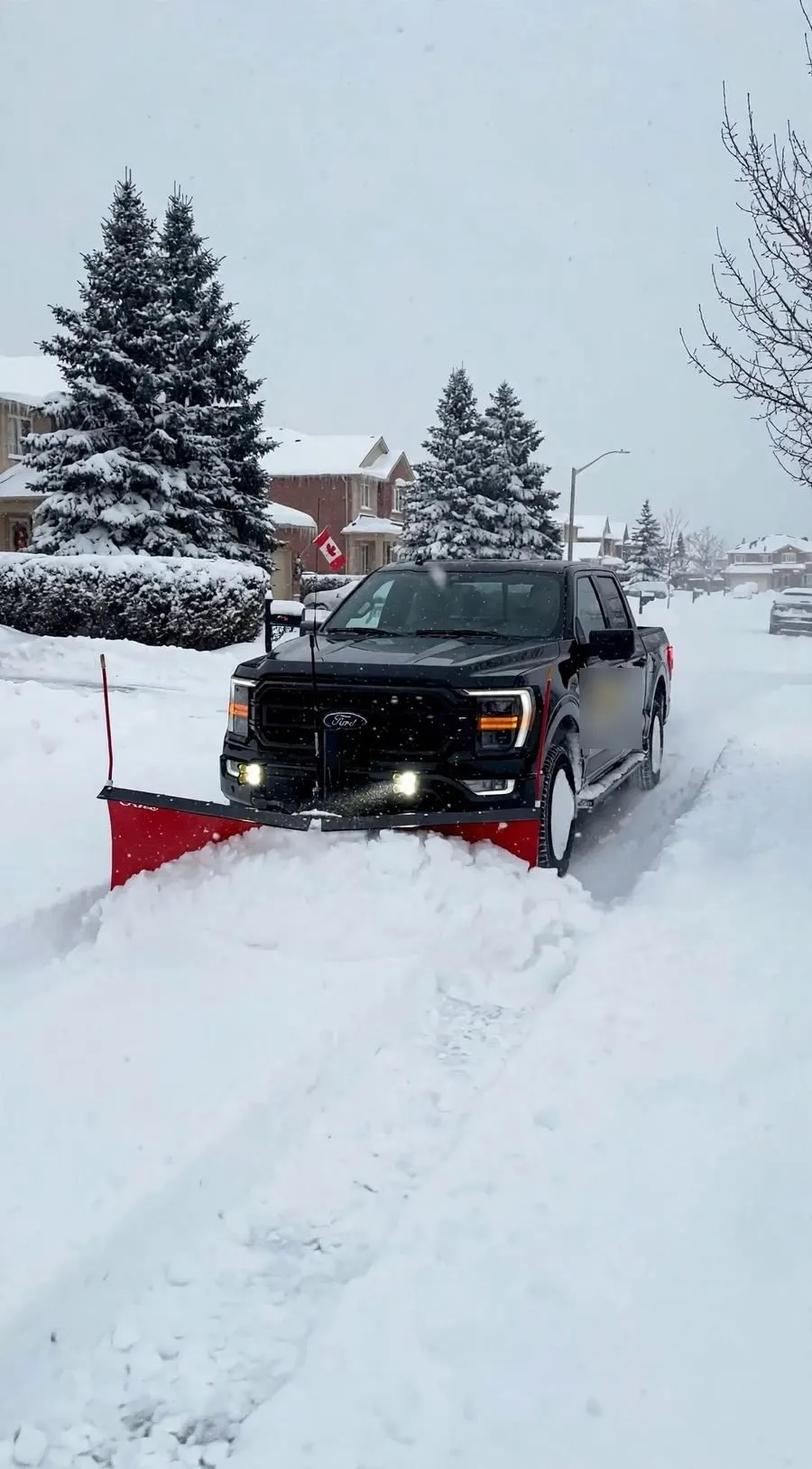 Plow truck clearing a snow-covered street